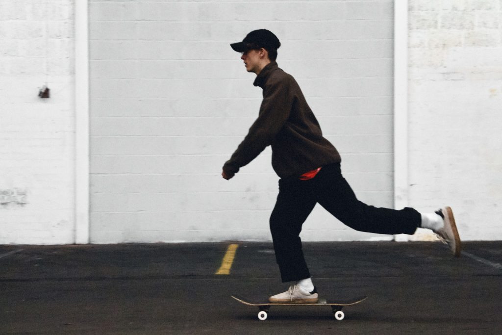 a boy skateboarding dressed all in black