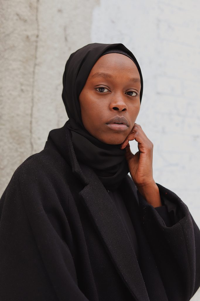 Black Female wearing a Hijab dressed all in black