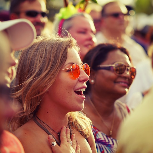 woman wearing sunglasses in sun at a festival