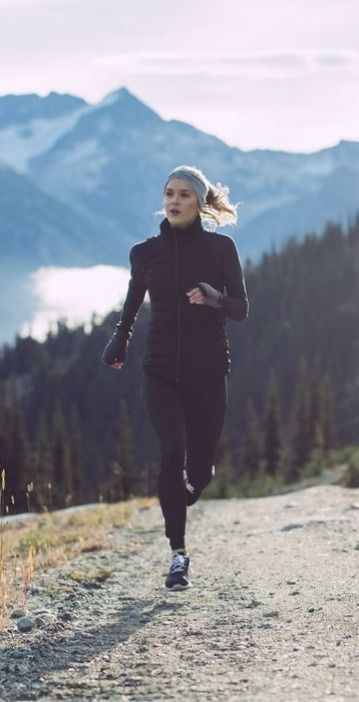 woman running on mountain road in sportswear